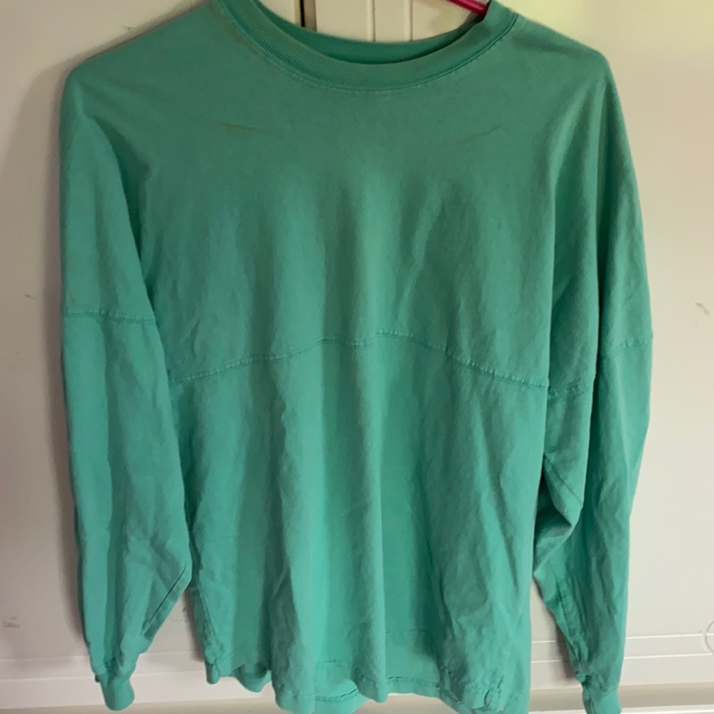 Aqua colored shirt with outer banks on the back